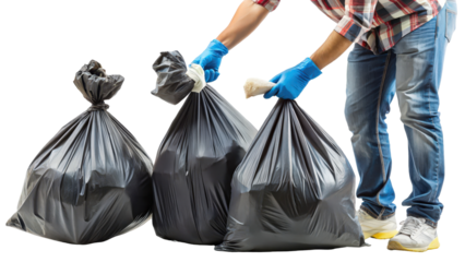 Man carrying multiple black garbage bags while holding a piece of trash in a well-lit setting demonstrating waste management practices