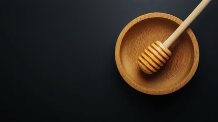 Honey and wooden dipper isolated on black background, top view