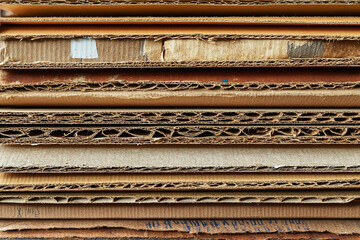 Recycled cardboard stack cross-section, texture detail.