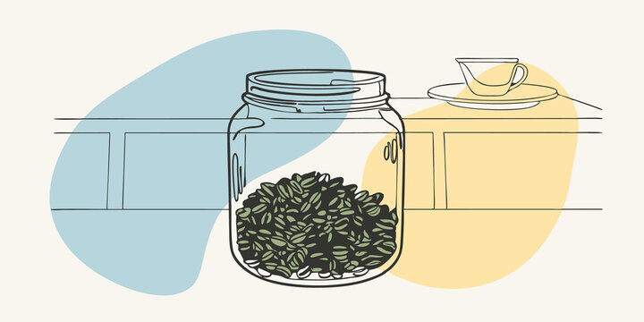 A glass jar filled with freshly ground coffee sits on the counter rich aromas wafting upward promising a rich flavor with every sip.