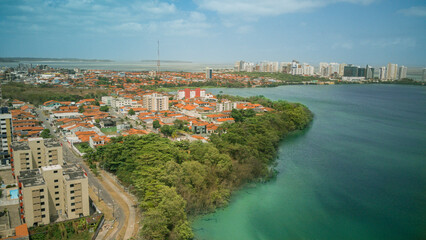 Fototapeta premium Panoramic drone view of Lagoa da Jansen, a lagoon in Sao Luis, Maranhao, Brazil. Beautiful urban landscape with nature, water, and the city skyline in harmony.
