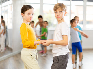 Couple boy and girl dancing ballroom waltz dance in studio