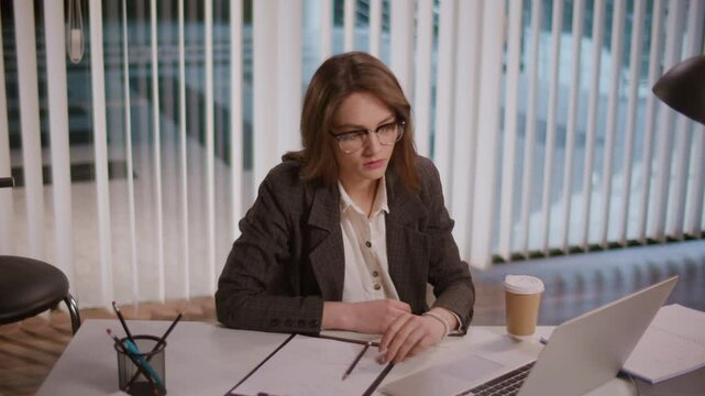 A Businesswoman Feels Fatigue Working on a Computer in a Modern Office. Highlighting the Importance of a Flexible Work Schedule and Recovery Resources to Combat Fatigue. Stress Management Needed.
