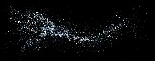 Whirlwind vortex of white snow swirling in the wind on black background