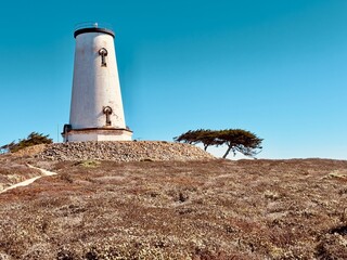 Piedras Blancas Light Station on the rugged California coast, with its historic lighthouse standing...