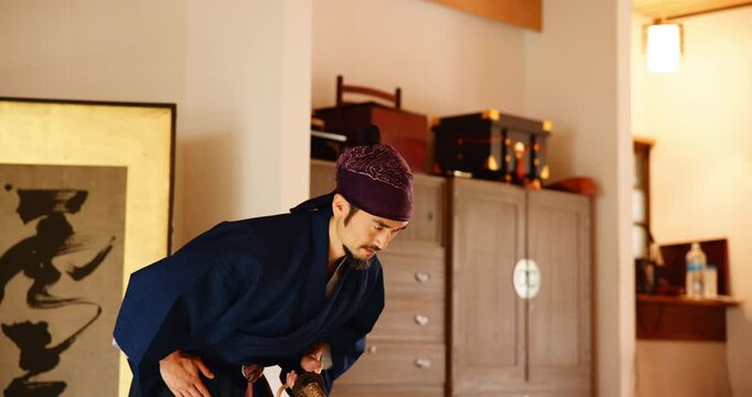 Warrior, bow and martial arts sensei in dojo for practice routine, bushido and spirituality. Respect, Japanese man and virtues for fighting, tradition and samurai culture for technique discipline