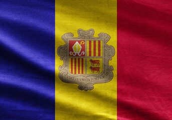 Andorra flag with detailed embroidery texture and soft fabric folds, showcasing vibrant blue, yellow, and red with a national coat of arms.