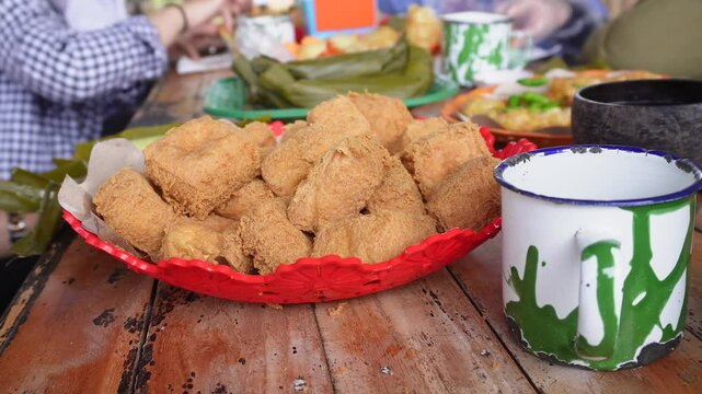 eating together at a tofu restaurant in Sumedang, West Java, Indonesia. Apart from the tofu menu, there are also lontong (sticky rice) and fritters food, serve with sambal or dipping sauce