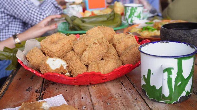 eating together at a tofu restaurant in Sumedang, West Java, Indonesia. Apart from the tofu menu, there are also lontong (sticky rice) and fritters food, serve with sambal or dipping sauce