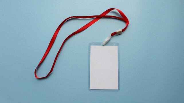 Red lanyard with blank badge isolated on blue background