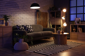 Interior of modern living room with sofa and coffee table at evening