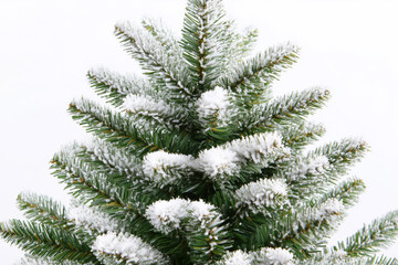 Close-up image of green snowy artificial Christmas tree