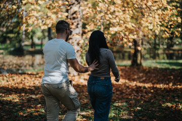 Fototapeta premium A couple enjoys a walk through an autumn park, surrounded by vibrant fall leaves. The scene captures a sense of romance and tranquility in nature, reflecting the warmth of the season.
