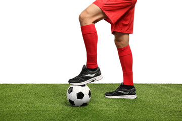 Football player with soccer ball on artificial grass against white background, closeup