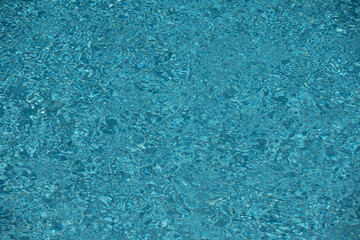Obraz premium Pool water surface with copy space. Water surface in swimming pool. Blue water background. Clear sea water texture. Sea ocean background.