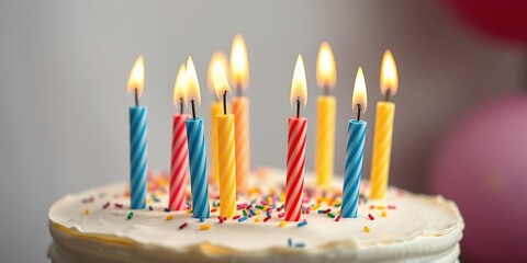 Close-up of colorful candles on top of a vanilla birthday cake, candle decoration, dessert photography
