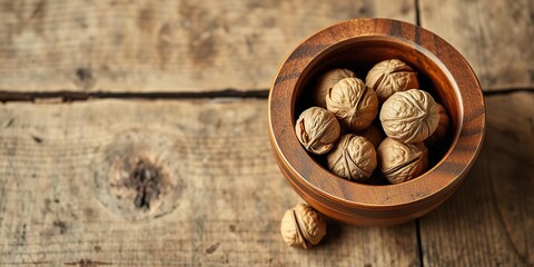 Fototapeta premium A few shelled walnuts in a wooden mortar on a rustic wooden table, interior design, food, cooking utensils