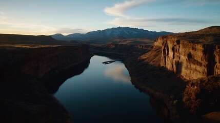 A solitary figure stands on a cliff, overlooking dramatic mountains and clouds, evoking a sense of adventure and exploration.