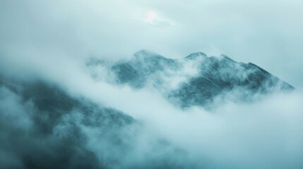 Obraz premium Dense fog and low-lying clouds covering a mountain range, creating a mystical and ethereal scene