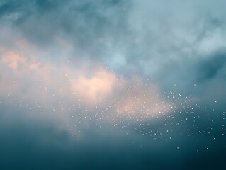 Obraz premium Soft, ethereal glow of light particles dispersed in a cloudy sky.