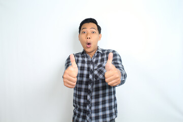 Fototapeta premium surprised asian man show thumb up and like gesture with funny face isolated on white background