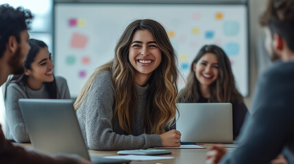 Happy businesswoman smiling during a meeting with colleagues in the office