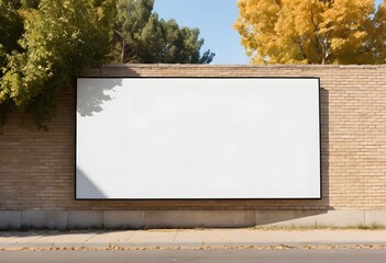 Empty billboard providing advertising space on a brick wall by a street with trees, perfect for showcasing marketing campaigns
