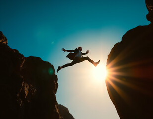 businessman jumping between two boulders outdoors , take a big step