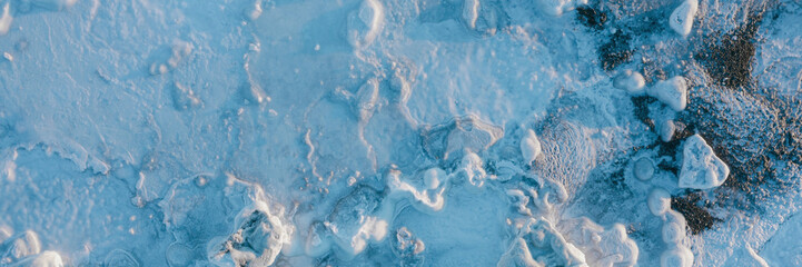 Top view of the ice. Winter aerial photograph of ice floes on the coast. Amazing northern nature. Frosty winter weather. Cold arctic climate. Extreme North. Wide panoramic background. Great for design © Andrei Stepanov
