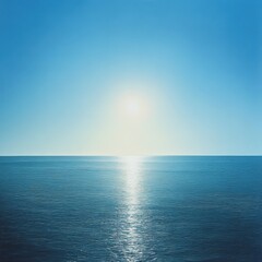 Fototapeta premium serene ocean view with bright sun reflecting on calm waters