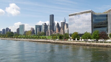 Fototapeta premium New York City skyline from ferry boat. Manhattan midtown near Queensboro bridge to Queens. Highrise architecture from ferryboat. East river waterfront riverfront architecture. Roosevelt Island, USA.