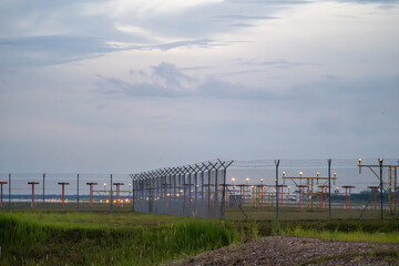 Obraz premium A close-up view of the approach lighting system (ALS) at an airport runway. These specialized lights guide pilots during the final approach and landing, ensuring safety.