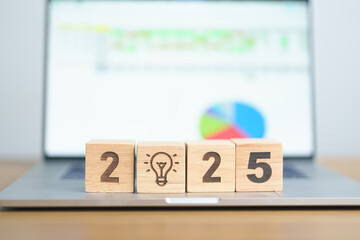 2025 Year block with lightbulb icon against computer laptop background. Business Idea, Creative,...