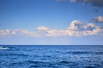 Fototapeta premium Tranquil seascape with blue sky and clouds