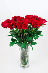 red roses in vase isolated on white background