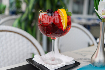 Drinking sangria. Glass of sangria aperitif beverage. Summer drink. Cocktail in bar. Aperol spritz...