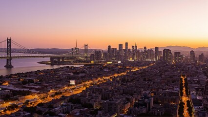 Naklejka premium Generative AI, Sprawling Urban Skyline with a Suspension Bridge at Sunset