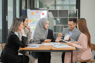 Fototapeta premium Asian Business Group Chat about graph work Present in meetings, in the office