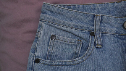 Detail shot capturing the pockets and seam details of blue denim jeans