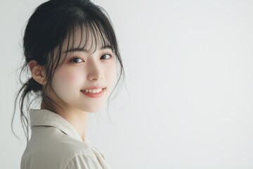 Fototapeta premium Young Japanese woman in business casual attire, smiling and looking directly at the camera with confidence against Portrait of a professional office worker confident young entrepreneur on isolated 