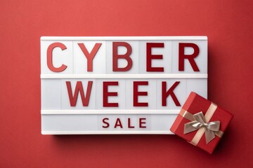 Cyber Week Sale written white lightbox sitting on red podium before red background