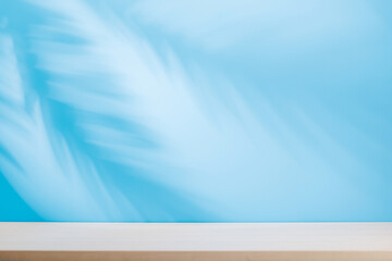 Template with empty table and wall with natural plant shadow and sunny glare