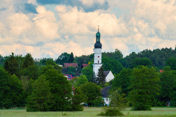 Pfaffenhofen Church Tower embedded in village and surrounding spring green trees