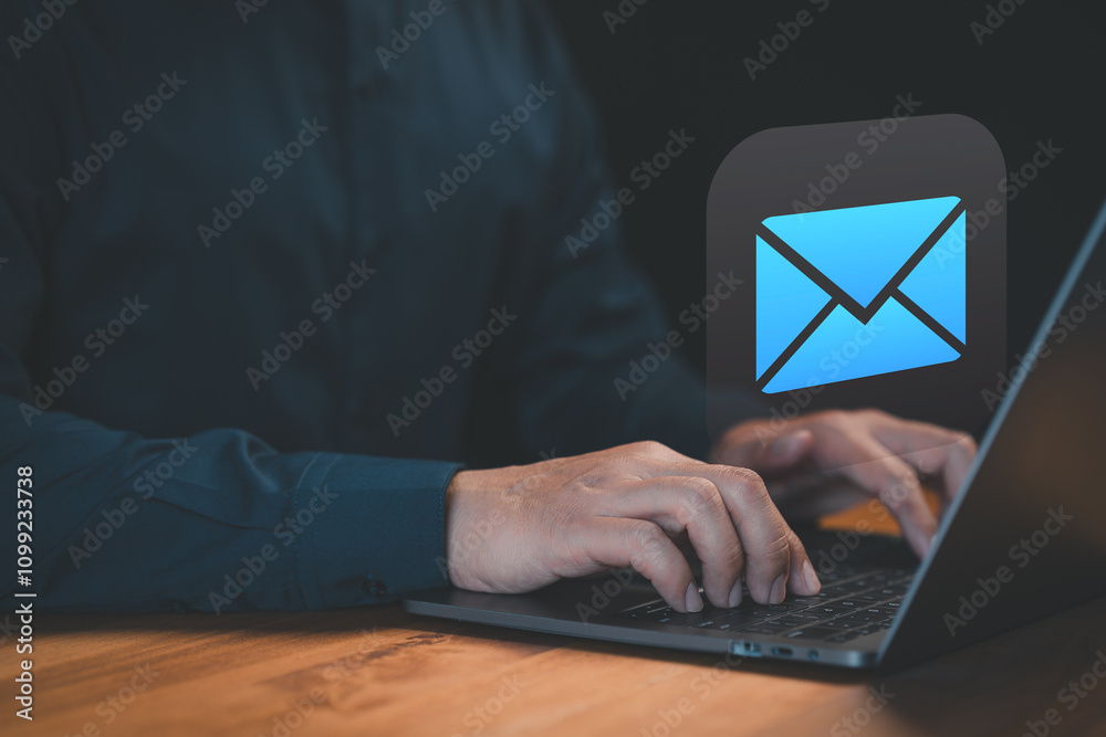 Poster hands typing on a laptop keyboard with a glowing email icon above, symbolizing digital communication