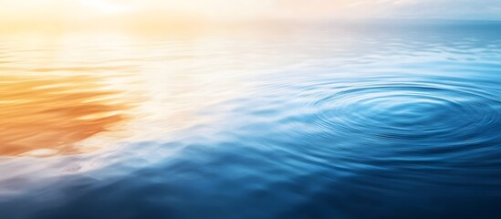 Obraz premium Calm water surface with ripples at sunset.