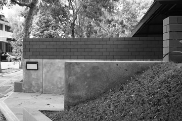 Cement walls with red bricks and grass with trees in the background