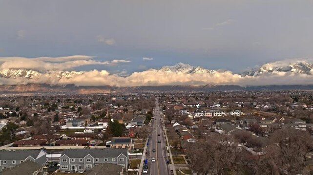 Aerial over beautiful neighborhood street and mountains view on Midvale Utah