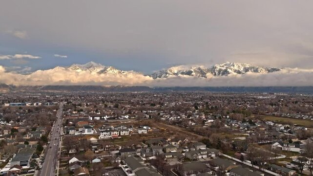 Flying over beautiful neighborhood with stunning mountains views on Midvale Utah