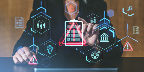 Business person navigating risk management and safety icons on a transparent interface. Focus on checklist with alert symbol in a digital setting.