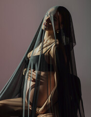 beautiful pregnant woman in studio under dark veil like virgin mary